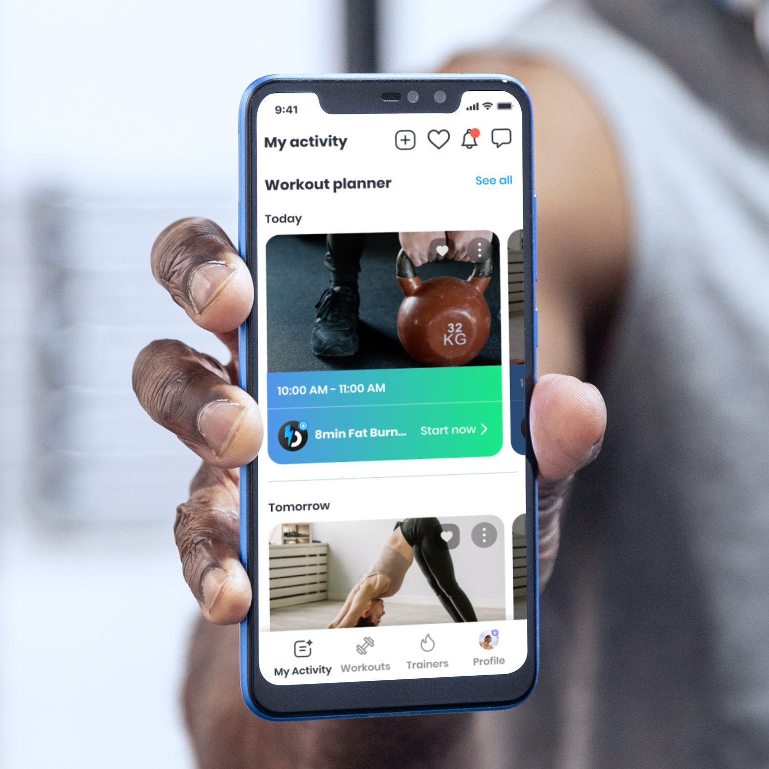 Hand of a man holding blue smartphone showing bim workout planner page