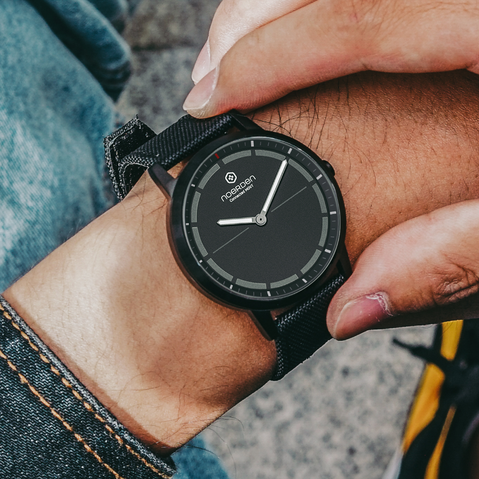 Mate2+ Black watch focus on male wrist with denim sleeve and pants