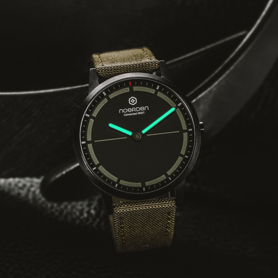 Mate2+ khaki smart watch on black display with luminous hands